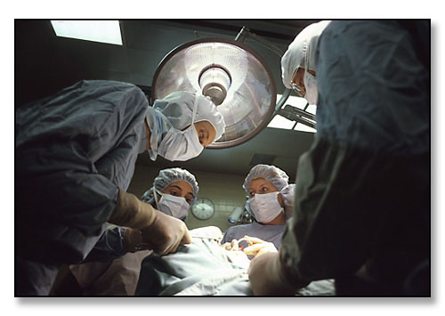 Brown University medical student, Betsy August (bottom left), observing surgery during surgical clerkship. <br>Rhode Island Hospital, Providence, Rhode Island. July 1982.