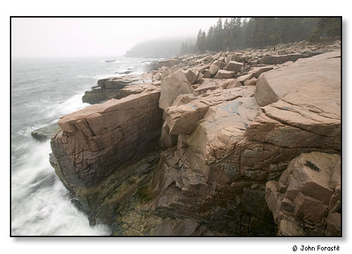 Coast, granite rock, surf and fog in rain. Acadia National Park, Maine. April 2004.