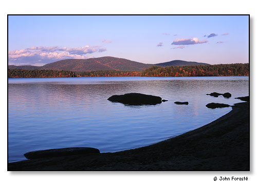 Early evening in the fall on Squam Lake. The White Mountains of New Hampshire.