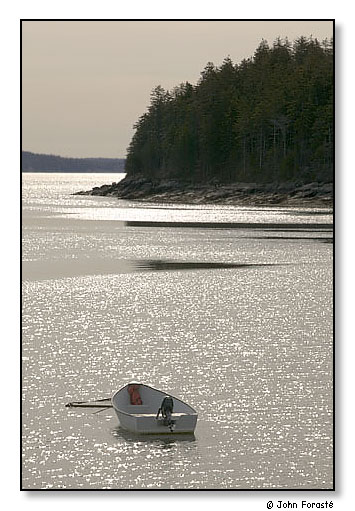 Boat and sun on water. Deer Isle, Maine. April 2004.