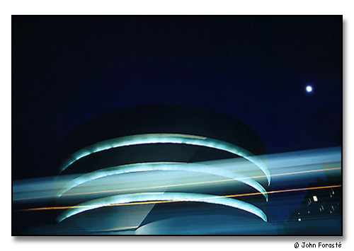 The Guggenheim Museum, moon and passing bus. <br>New York City. Circa 1970.