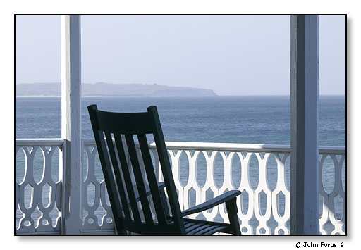 Rocking chair looking out to the cliffs at Clay Head.<br>The Surf Hotel, Block Island, Rhode Island. May 2004.