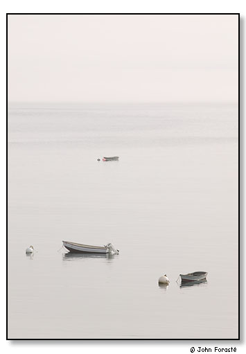 Three boats in calm harbor. Monhegan Island, Maine. July 2004.
