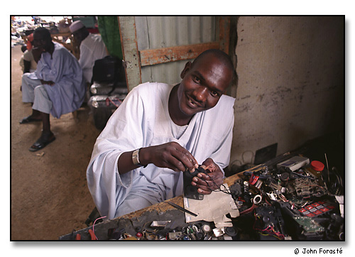 Camera repairman in market. <br>Maroua, Cameroon, (central west) Africa. August 2002.